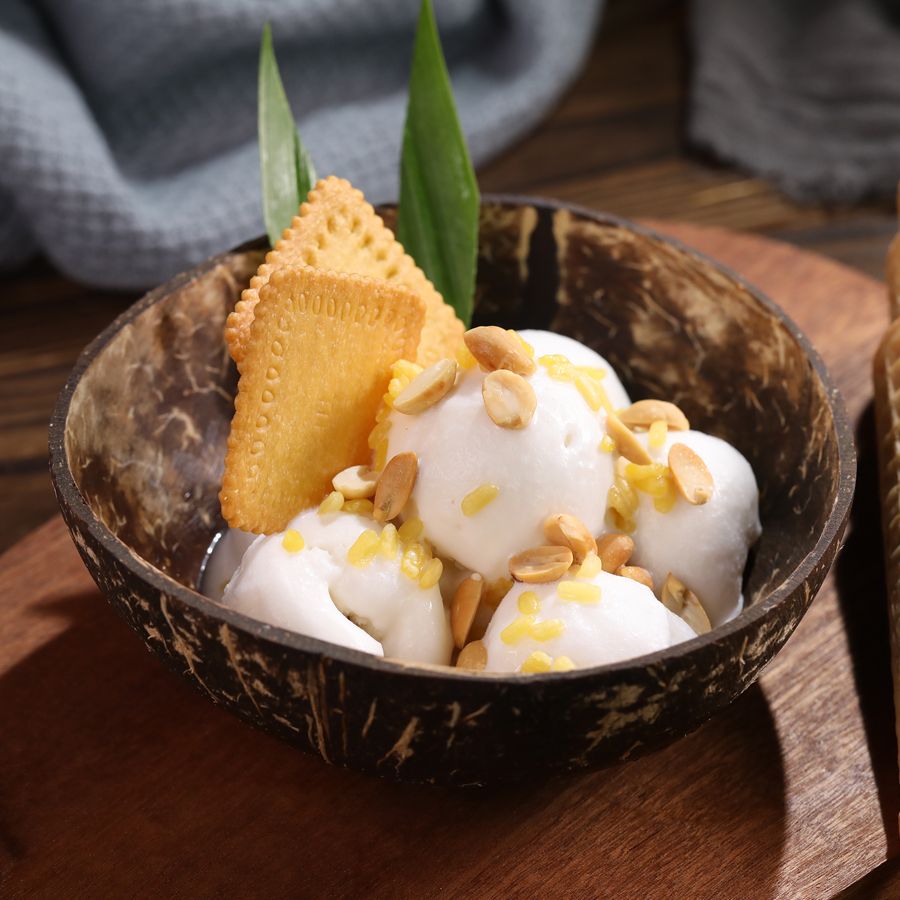 Creamy Coconut Ice Cream Topped with Peanuts and Crackers