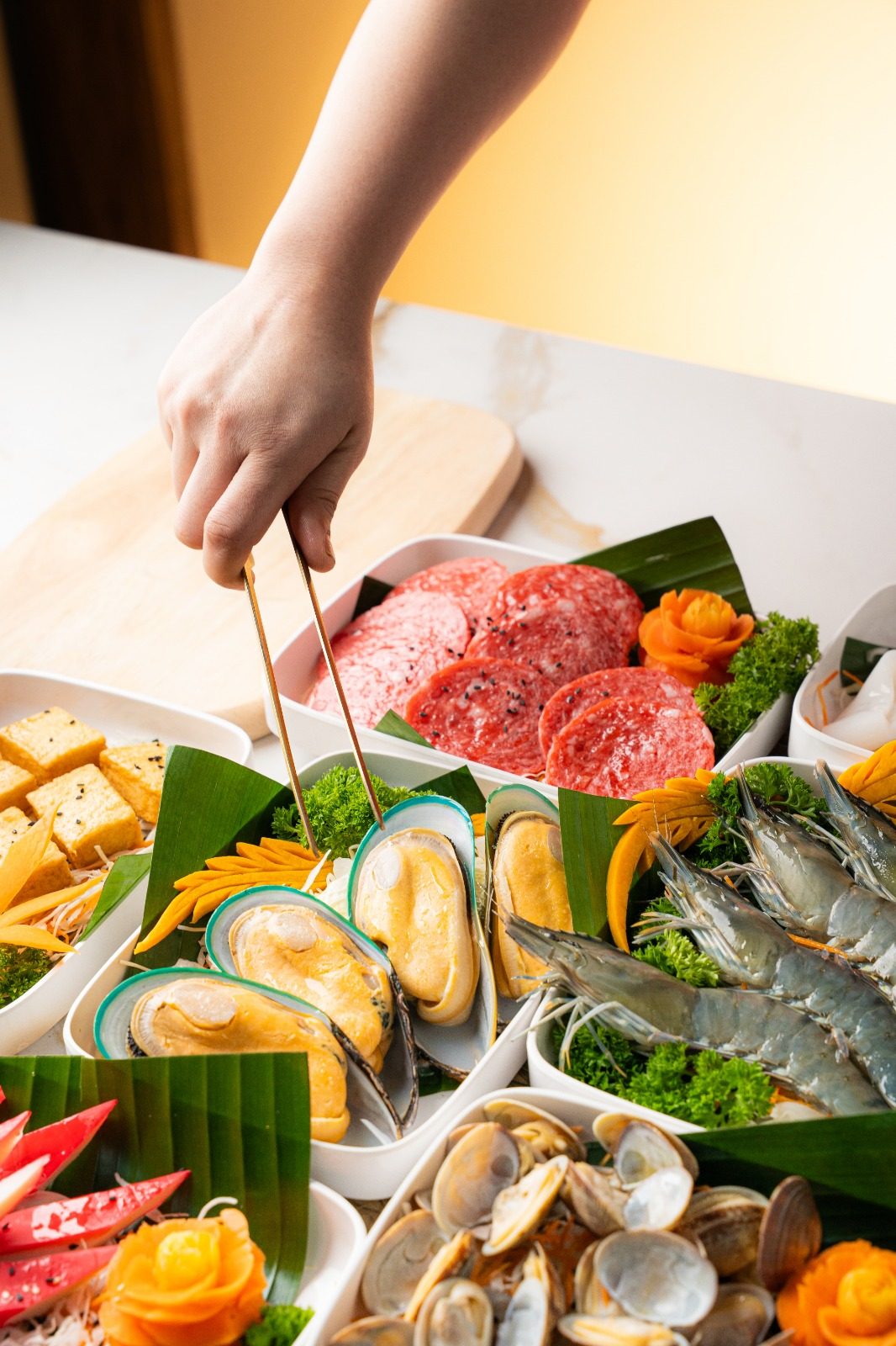 A fresh mookata spread of meats, prawns, mussels and clams