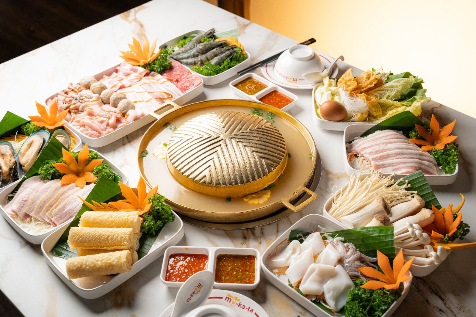 Top-down mookata spread with the golden dome grill